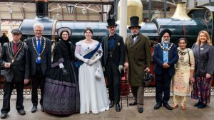 Queen Victoria and Prince Albert pose for photos with VIPs in front of replica Dean Single 4-2-2 No.3041 'The Queen' - Great Western Railway