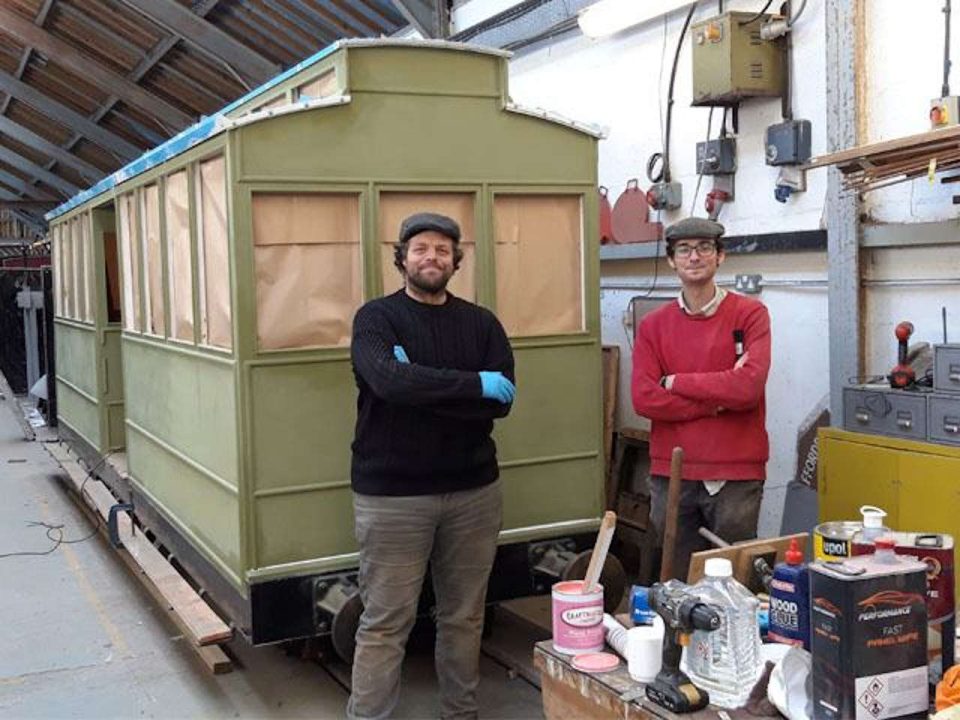 Volunteers Theo and Zach after painting preparation