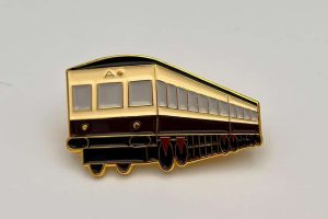 Enamel badge depicting the last Drumm battery electric train. // Credit: Táilte Tours CLG