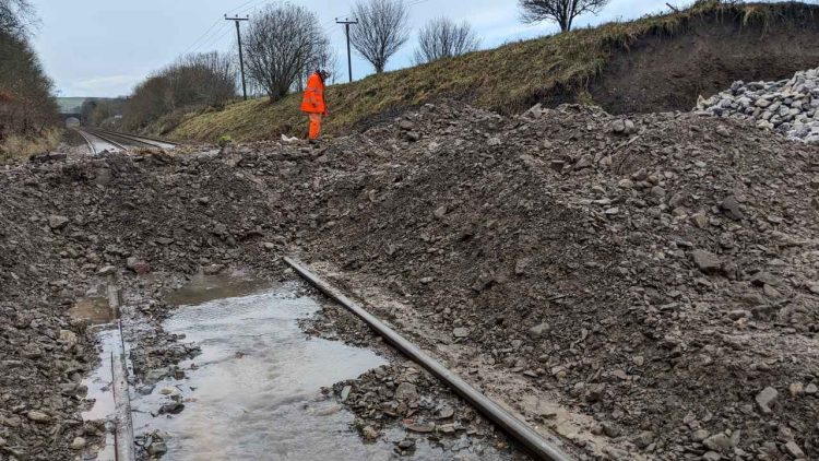 A railway engineer inspects the site where a railway cutting collapsed due to flooding - Network Rail