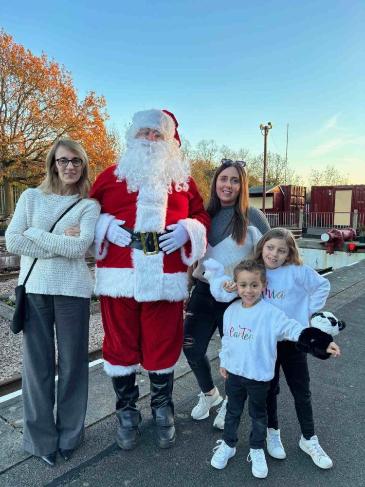 Santa spreading festive joy with a young family - Great Central Railway