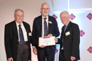 Andy Savage MBE presenting the award to John Bennett and John Bruce for the Goathland Station Weighbridge Office project - NYMR